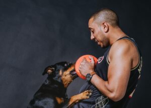 Amr Nawwar plays ball with his dog, Molly the Rottweiler