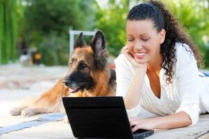 girl with dog on computer